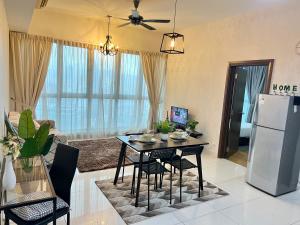cocina y sala de estar con mesa y nevera en Luxury Regalia suites by adnan, en Kuala Lumpur