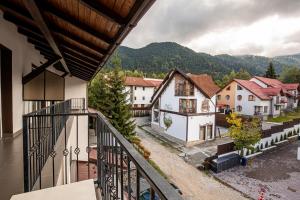 an apartment balcony with a view of a village at Artemis Villa in Poiana Brasov