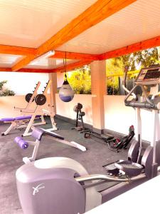 a gym with several exercise equipment in a room at Holiday Houses Luan in Poreč
