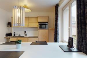 a kitchen with a white counter top in a room at Quai Saint-Leonard - La Renommée liege in Liège