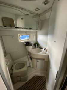 a small bathroom with a toilet and a sink at Yate Gijon , experiencia unica J in Gijón