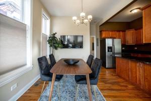 a kitchen with a table and chairs and a refrigerator at Getaway in the Heart of Pilsen Chicago in Chicago