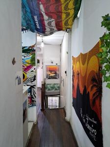 a hallway with colorful murals on the walls at Simple single room Botafogo, Copacabana beach in Rio de Janeiro