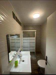 a bathroom with a sink and a toilet and a mirror at Los Cristianos port royal in Los Cristianos