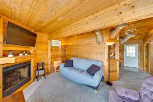 a living room with a blue chair and a fireplace at Lakefront Wisconsin Escape with Boat Dock and Kayaks! in Oconomowoc