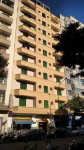 a large apartment building with cars parked in front of it at Pax Hotel , próximo da 25 de Março, Brás, Bom Retiro e República in São Paulo