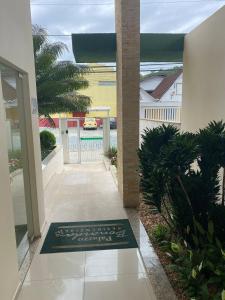 a hallway of a house with a rug on the floor at RCM Vilas - Loft mobiliado in Joinville