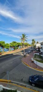 a street with a car parked on the side of the road at Apartament central frente al mar in San Felipe de Puerto Plata