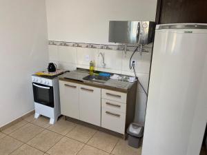 a small kitchen with a sink and a stove at RCM Vilas - STUDIO n 05 in Joinville