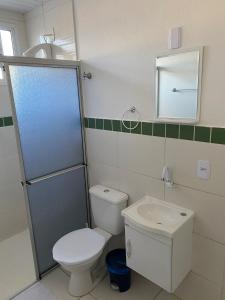 a bathroom with a toilet and a sink at RCM Vilas - STUDIO n 05 in Joinville