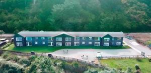 an aerial view of a large building with a driveway at ApartHotel Kintumay in Puerto Varas