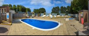 a large swimming pool sitting on top of a patio at Kathy's Warden springs caravan in Leysdown-on-Sea