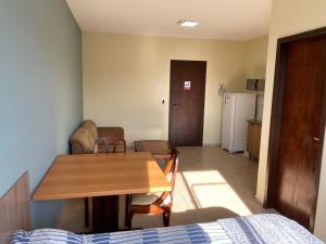 a room with a dining table and a kitchen at RCM Vilas - STUDIO n17 in Joinville