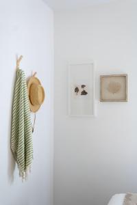 a white room with a hat and pictures on the wall at Riviera Beach House in Santa Barbara