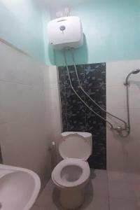 a bathroom with a toilet and a sink at OYO 93101 Al-ainah Family Homestay in Medan