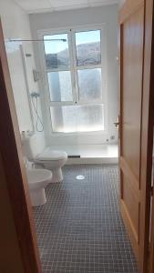 a bathroom with two toilets and a window at Hotel Rural-Restaurante Los Olivos in Almería