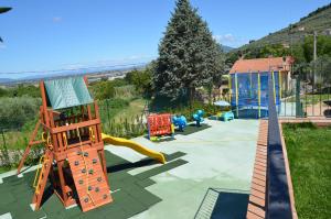 a playground with a slide and play equipment at Il Borgo Dell'Ulivo in Trevi +20 photos
