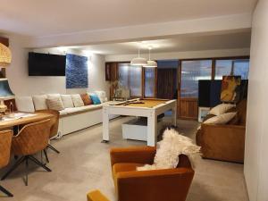 a living room with a couch and a table at Apartments Eva in Umag