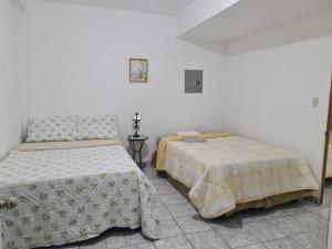 Postel nebo postele na pokoji v ubytování Estrada residence