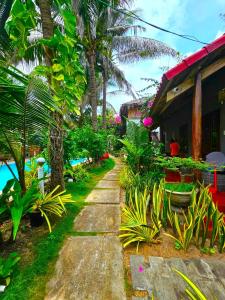 a walkway in front of a house with palm trees at Casa Beach Resort in Phan Thiet