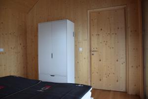 a bedroom with a white cabinet and a door at Blickfang Tirol in Innsbruck