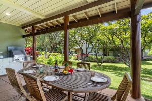 a wooden table and chairs on a patio at Mauna Lani Fairways 1101 in Waikoloa