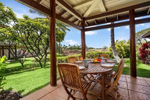 a wooden table and chairs on a patio at Mauna Lani Fairways 1101 in Waikoloa