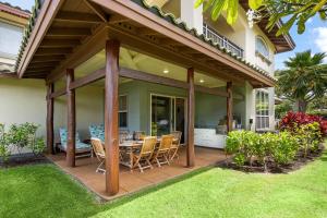 a patio with a table and chairs on a lawn at Mauna Lani Fairways 1101 in Waikoloa +46 photos