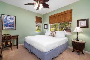 a bedroom with a white bed and a window at Mauna Lani Fairways 1101 in Waikoloa
