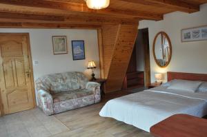a bedroom with a bed and a couch at Central Łeba Suites in Łeba