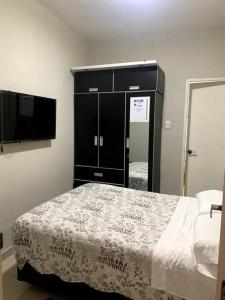 a bedroom with a bed and a black cabinet at Apartamento Miraflores in Lima