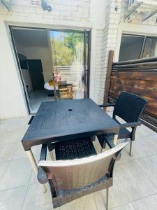 a wooden table and chairs on a patio at The Bliss Boutique in Louis Trichardt
