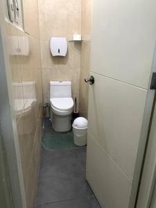 a small bathroom with a toilet and a refrigerator at Apartamento Miraflores in Lima