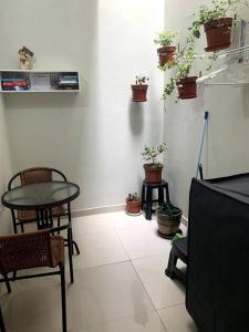 a room with a table and chairs and potted plants at Apartamento Miraflores in Lima