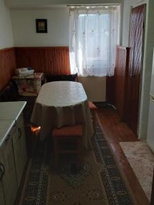 a kitchen with a table and chairs and a window at DAION in Bistriţa