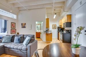 a living room with a couch and a table at Downtown Los Angeles Condo with Shared Rooftop Pool! in Los Angeles