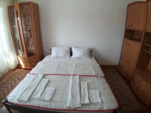 a large bed in a room with two dressers at DAION in Bistriţa