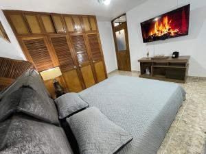 a bedroom with a bed and a fireplace at Medellin Tu hogar en la eterna primavera in Medellín