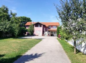 a house with a driveway in front of it at Guest House Lucija in Zagreb