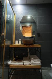 a bathroom with a sink and a shelf with towels at ASTARTE HOTEL in Urfa