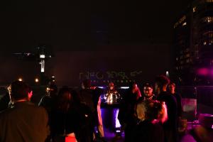 a group of people standing around in the dark at The Godfrey Hotel Hollywood in Los Angeles +125 photos