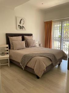 a bedroom with a large bed and a window at Apartments Hout Bay in Cape Town