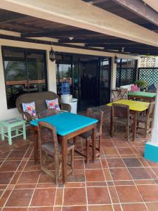 a patio with tables and chairs on a patio at Uverito Sand Dollar B&B in Las Tablas