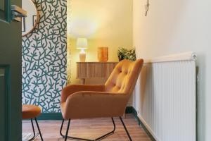 una silla naranja en una habitación con radiador en Home from Home 4 Bed - Ideal for Workers & Great for Groups, FREE Parking, Spacious, Pet Friendly Netflix en Kimberworth