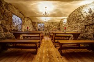 a room with wooden benches and a stone wall at Penzion Sally in Albrechtice v Jizerských horách