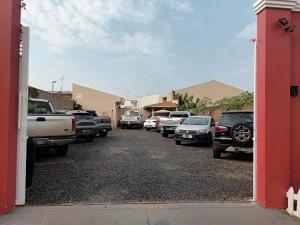 a bunch of cars parked in a parking lot at Hotel Rosa Viva in Barretos