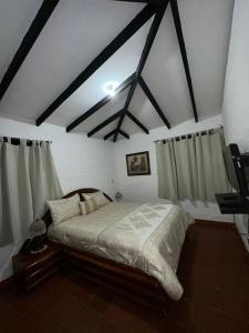 a bedroom with a large bed in a room at Rancho 4Js in La Cumbre