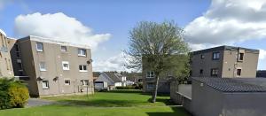 a view of two buildings and a yard at Serviced Apartment - Aberdeen in Dyce