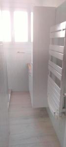 a white bathroom with a sink and a window at Appartement 2 chambres parking Port Fréjus Base Nature in Fréjus +6 photos
