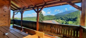 a balcony of a cabin with a view of the mountains at Casa Magnolia in Bran